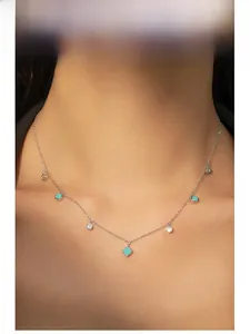 Close-up of S925 silver bohemian choker with turquoise and crystal charms on a model
