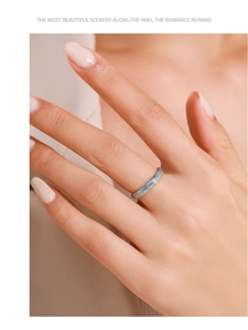 Macro detail of silver geometric enamel ring with sky blue pattern and micro-set zircons