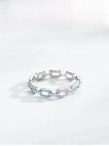 Macro detail of S925 silver chain ring with pastel enamel links and pavé zircons