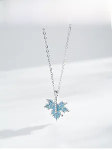 Detailed view of S925 silver maple leaf pendant with blue enamel and micro-pave zircons