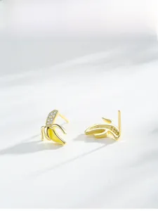 Detailed view of banana-shaped S925 silver earrings with pavé zircons and yellow enamel