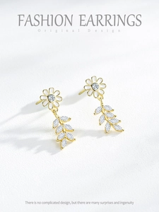 Detailed shot of S925 silver daisy earrings with enamel petals and zircon leaf drops