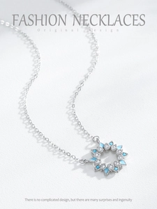 Macro detail of S925 silver sunflower pendant with blue enamel and white zircon stones