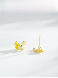 Detail of S925 silver ginkgo leaf earrings with yellow enamel and 14K gold plating