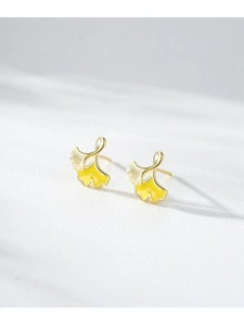 Macro shot of S925 silver ginkgo leaf stud earrings with yellow enamel and 14K gold plating
