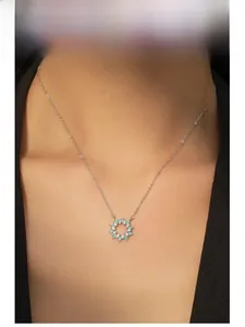 Close-up of S925 silver sunflower necklace with turquoise pendant on a model