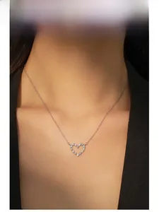 Model wearing a refined S925 sterling silver heart pendant necklace with purple zircons