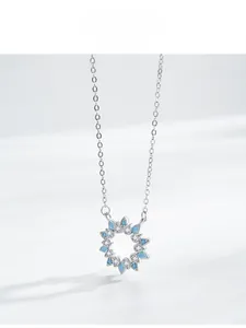 Detailed view of S925 silver sunflower pendant with turquoise stones and white diamonds