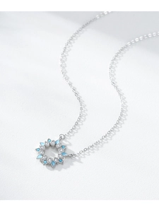 Detailed shot of S925 silver sunflower pendant with turquoise enamel and pavé zircons