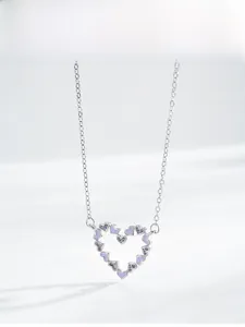 Close-up of S925 silver heart pendant with purple enamel and zircon stones