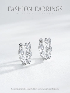Detailed close-up of 925 sterling silver hoop earrings with pavé set zircon stones