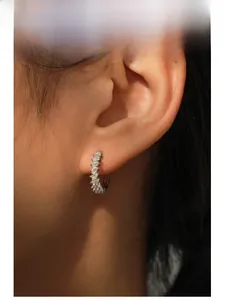 Gros plan de créoles en argent sterling S925 serties de zircons de taille baguette