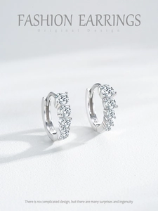 Detailed close-up of S925 sterling silver earrings showing material hallmark and zircon stones