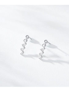 Detail view of wavy spiral earrings featuring micro-set cubic zirconia in silver finish