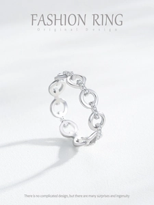Macro detail of silver chain link ring featuring sparkling micro-pave cubic zirconia accents