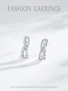 Detail of wavy S925 silver stud earrings with sparkling round cubic zirconia stones