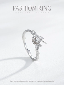 Detailed macro view of silver rose ring with branch texture and zircon center
