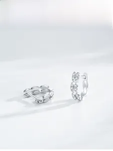 Macro detail of 925 sterling silver hoop earrings with double-row sparkling zircons