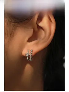 Close-up of model wearing S925 sterling silver geometric stud earring with zircons
