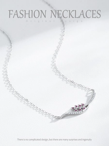 Macro detail of S925 silver necklace with red marquise stones and micro-pave crystals