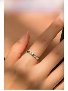 Macro detail of S925 sterling silver star ring featuring zircon inlay on model finger