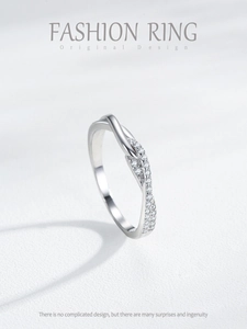 Macro view of S925 silver criss-cross ring band with elegant pavé zircon setting