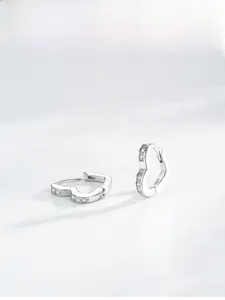 Detailed close-up of S925 sterling silver heart earrings with micro-inlaid zircon stones