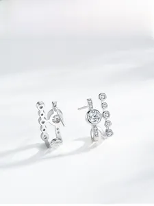Macro shot of S925 silver geometric stud earrings with sparkling cubic zirconia inlay