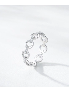 Macro shot of 925 sterling silver chain ring with pavé diamonds on textured surface