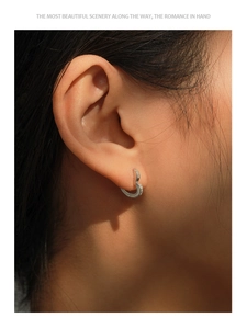 Close-up of S925 sterling silver heart hoop earring with shimmering micro-pave crystals
