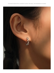 Detail of silver chain link hoop earrings with sparkling pavé cubic zirconia