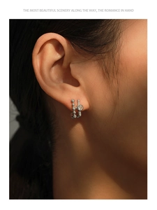 Macro detail of S925 sterling silver geometric stud earring with sparkling cubic zirconia