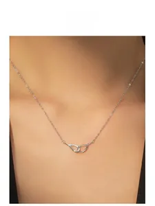 Close-up of S925 sterling silver angel wing necklace with pave cubic zirconia on a model