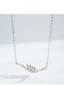 Macro view of S925 silver necklace with pink gems and wheat leaf shaped pendant
