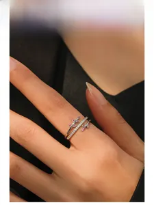 Detail of S925 silver leaf ring featuring red marquise gems and pave diamonds on hand