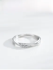 Macro shot of S925 sterling silver criss-cross ring with pavé-set shimmering diamonds