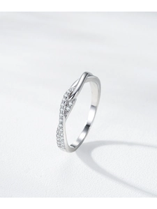Macro detail of S925 silver infinity ring featuring a polished band and pavé cubic zirconia