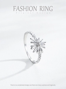 Macro shot of S925 sterling silver daisy ring with twisted band and floral texture