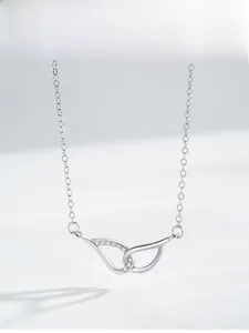 Detailed view of S925 silver angel wing necklace with micro-set zircons and twin rings