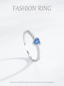Close-up of S925 silver ring featuring a blue heart gemstone and woven band detail