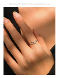 Close-up of 925 silver angel wing ring with pavé diamonds on woman finger