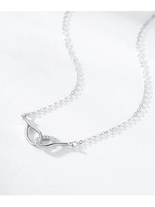 Macro shot of S925 sterling silver Mobius necklace with sparkling cubic zirconia detail