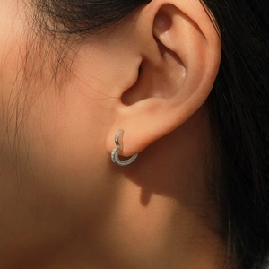 Elegant S925 sterling silver heart hoop earrings with pavé zircons on model ear