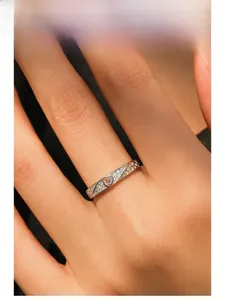 Detailed macro view of S925 silver heart ring with pavé-set stones and hollow texture