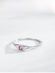 Detail of pink round gemstone set in S925 sterling silver ring with openwork head