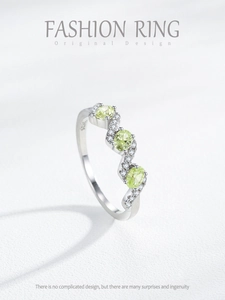 Detailed macro of S925 silver ring featuring three oval green zircons and micro-pave diamonds