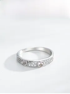 Macro shot of S925 sterling silver ring with champagne heart gem and honeycomb cutout detail