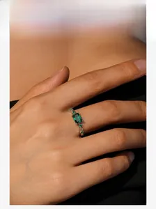 Close-up of S925 silver emerald cut green gemstone ring worn on a finger