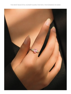 Close-up of S925 silver ring featuring an oval pink gemstone and three-stone setting