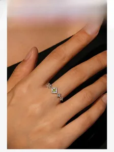 Close-up of S925 silver crown ring with square green zircon and micro-paved diamonds